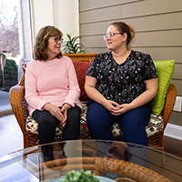 A resident and nurse spending time togther on an outdoor patio